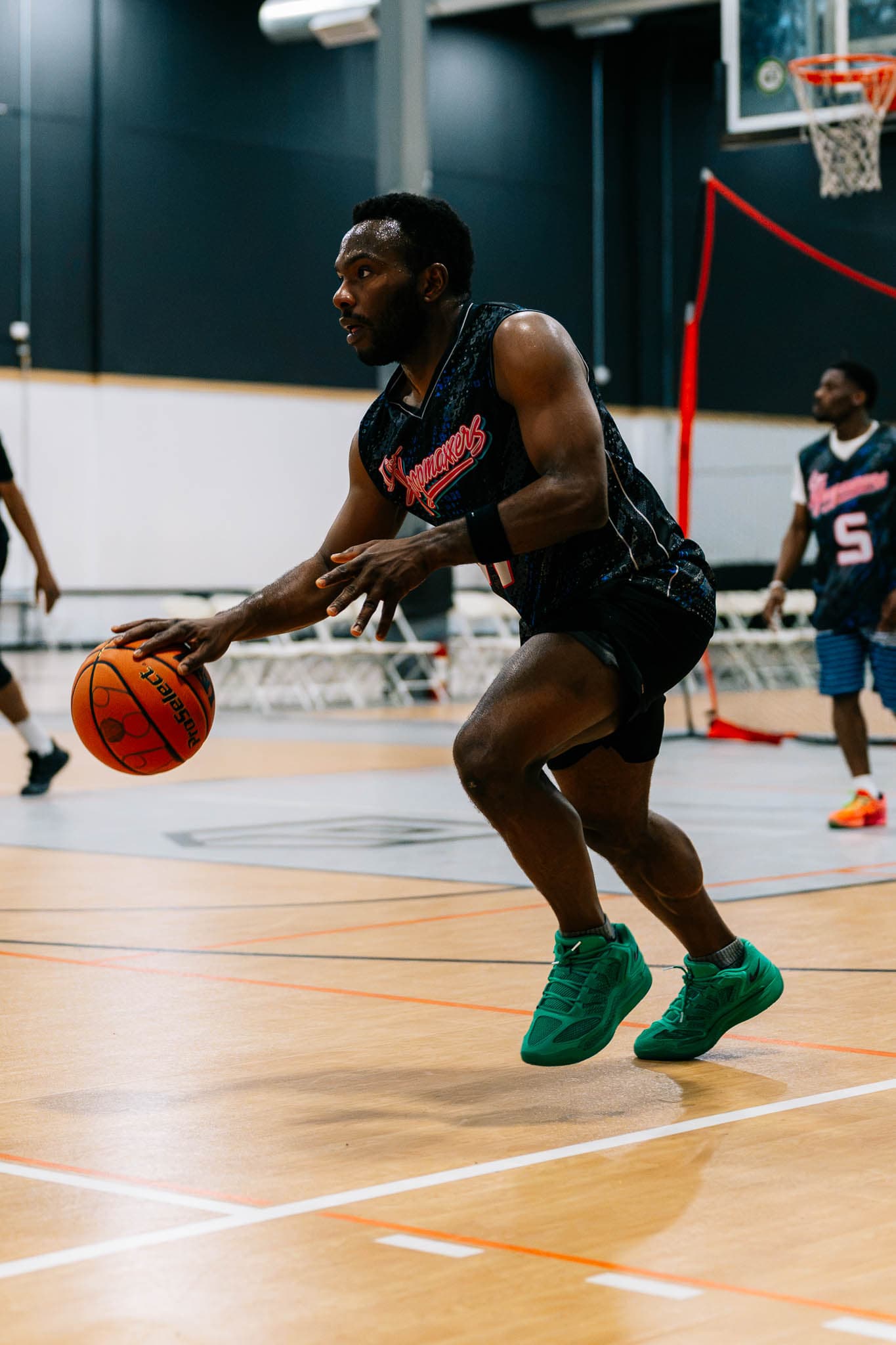 A player in a custom jersey attacking off the dribble
