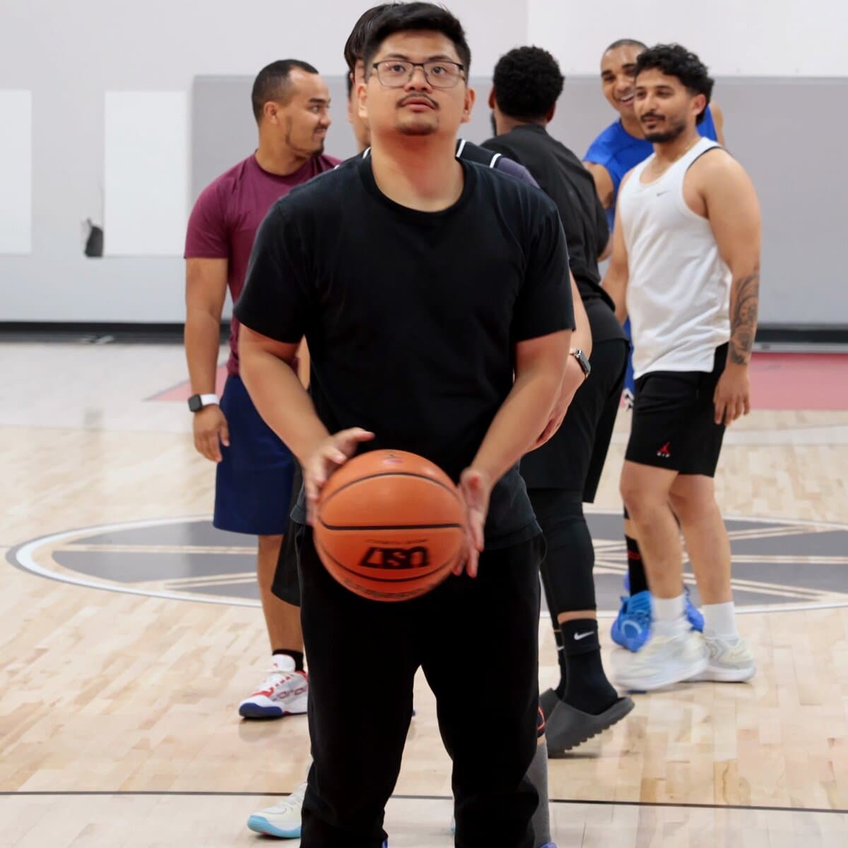 A player preparing a free throw with other players behind him at Shoot 360 Calgary