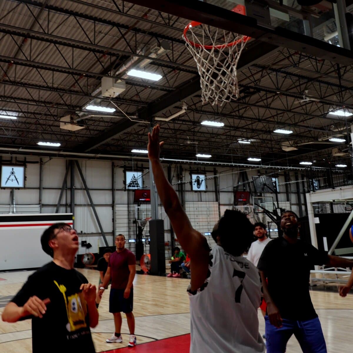Bodies at the rim waiting on the rebound