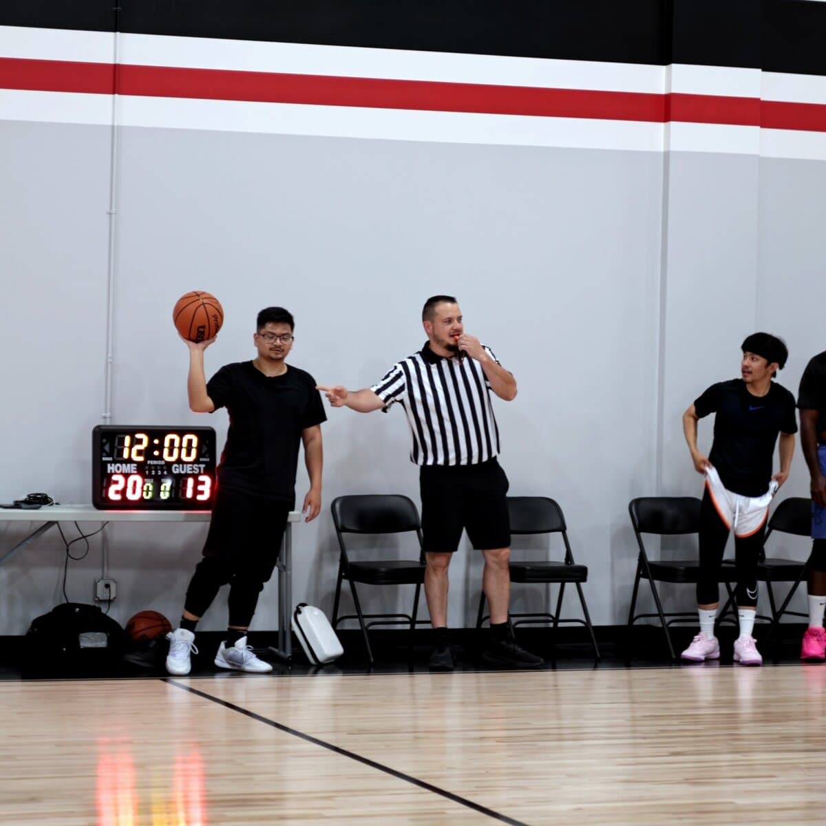 Referee calling it in from the scorer's table with the game clock running